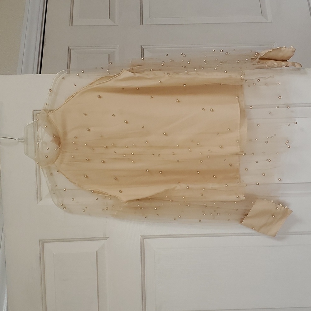 Pearl covered blouse.